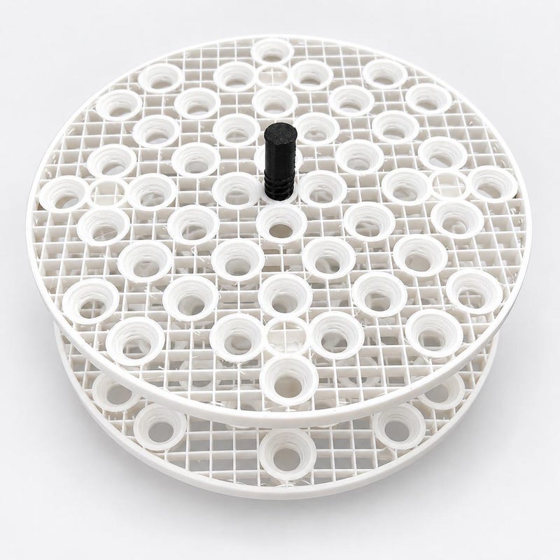 White circular coral frag racks with plug holders and a black center handle.
